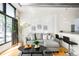 Cozy living room with a comfortable gray sofa, modern decor, and hardwood floors at 3100 Huron St # 1B, Denver, CO 80202