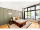 Cozy bedroom featuring unique bed frame, rug, and large window at 3100 Huron St # 1B, Denver, CO 80202
