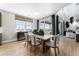 Spacious dining room with backyard views, modern table, and a black console at 4261 Ridgewalk Pt, Castle Rock, CO 80108