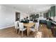 Bright dining area next to modern kitchen with green cabinets and stainless appliances at 4261 Ridgewalk Pt, Castle Rock, CO 80108