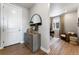 Entryway features a grey accent cabinet, mirror, and doorway to an office space with desk at 4261 Ridgewalk Pt, Castle Rock, CO 80108