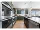 Well-lit kitchen showcases stainless steel appliances, dark green cabinetry and an island at 4261 Ridgewalk Pt, Castle Rock, CO 80108
