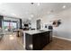 Kitchen island featuring bar stool seating, stainless steel dishwasher and sink with views to the dining area at 4261 Ridgewalk Pt, Castle Rock, CO 80108