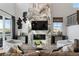 Bright living room featuring a stone fireplace, large windows, and modern decor at 4261 Ridgewalk Pt, Castle Rock, CO 80108