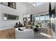 Spacious living room with modern decor, offering scenic views, and seamlessly connecting to an open concept kitchen at 4261 Ridgewalk Pt, Castle Rock, CO 80108