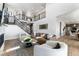 Bright open concept living room featuring modern decor, an elegant staircase, and seamless access to the kitchen at 4261 Ridgewalk Pt, Castle Rock, CO 80108