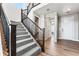Elegant staircase with a wooden banister and carpeted steps leading to the second floor at 4261 Ridgewalk Pt, Castle Rock, CO 80108
