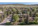 Stunning aerial view of a neighborhood nestled amongst lush greenery and rolling hills at 15000 W 29Th Ave, Golden, CO 80401