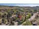 Aerial view of a neighborhood showcasing mature trees and picturesque landscape against a mountain backdrop at 15000 W 29Th Ave, Golden, CO 80401