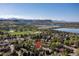 Picturesque aerial view highlighting a lush, green neighborhood near a lake and mountains at 15000 W 29Th Ave, Golden, CO 80401