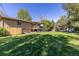 Beautiful home exterior showcasing the spacious backyard and well-manicured lawn at 15000 W 29Th Ave, Golden, CO 80401