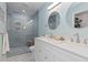 Updated bathroom featuring a double sink vanity, decorative tile floors, and a glass shower at 15000 W 29Th Ave, Golden, CO 80401