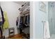 Walk-in closet beside a renovated bathroom with blue tile shower and neutral walls at 15000 W 29Th Ave, Golden, CO 80401