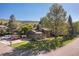Charming two-story home with mature trees, a well-kept lawn, and a long driveway at 15000 W 29Th Ave, Golden, CO 80401