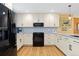 Bright kitchen features white cabinets, granite countertops, and a suite of modern stainless steel appliances at 15000 W 29Th Ave, Golden, CO 80401