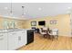 Open concept kitchen and dining area with modern lighting and stainless steel appliances at 15000 W 29Th Ave, Golden, CO 80401
