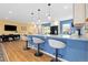 Open-concept kitchen features a breakfast bar with seating, modern lighting, and stainless steel appliances at 15000 W 29Th Ave, Golden, CO 80401