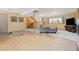 Living area with a TV, natural light, and wooden stairs at 15000 W 29Th Ave, Golden, CO 80401