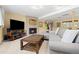 Inviting living room with a cozy fireplace, a neutral sofa, and a rustic wood coffee table at 15000 W 29Th Ave, Golden, CO 80401