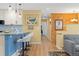 Living space with a view of the kitchen island with stool seating and stairs at 15000 W 29Th Ave, Golden, CO 80401