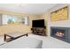 Comfortable living room area featuring a fireplace, a large TV, and a gray sofa at 15000 W 29Th Ave, Golden, CO 80401