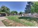 Expansive backyard with a lush green lawn, surrounded by mature trees and landscaping features at 17825 E Carolina Pl, Aurora, CO 80017