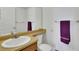 Bright bathroom featuring a large mirror, vanity, and purple towel at 17825 E Carolina Pl, Aurora, CO 80017