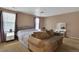 Bedroom features a large bed, sitting area, vanity, and soft natural light from windows at 17825 E Carolina Pl, Aurora, CO 80017