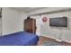 Cozy bedroom featuring a plush bed, dresser, and mounted television at 17825 E Carolina Pl, Aurora, CO 80017