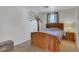 Inviting bedroom with a rustic wooden bed frame and tree mural accent wall at 17825 E Carolina Pl, Aurora, CO 80017