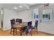 View of dining area with wood table and white door leading to back yard at 17825 E Carolina Pl, Aurora, CO 80017