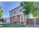 Charming two-story home featuring a brick facade, light grey siding, and well-maintained front yard at 17825 E Carolina Pl, Aurora, CO 80017