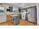 Functional kitchen with gray cabinets, wood countertops, and stainless steel refrigerator at 17825 E Carolina Pl, Aurora, CO 80017