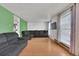 Bright living room with hardwood floors, a comfortable grey sofa, and large windows with natural light at 17825 E Carolina Pl, Aurora, CO 80017
