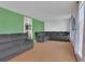 Inviting living room with hardwood floors, grey sofa, and a view into kitchen creating an open living space at 17825 E Carolina Pl, Aurora, CO 80017