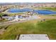 Aerial view of a park with lakes, a playground, a basketball court and grassy areas perfect for recreation at 3308 E 118Th Way, Thornton, CO 80233