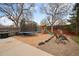 This backyard features a trampoline, play set, seating, grill, and stone landscaping, perfect for Gathering fun at 3308 E 118Th Way, Thornton, CO 80233