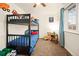 Cozy ' bedroom features a bunk bed, ceiling fan, and a bright window with playful decor at 3308 E 118Th Way, Thornton, CO 80233
