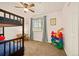 Bright ' bedroom with bunk bed, ceiling fan, and a window bringing in natural light at 3308 E 118Th Way, Thornton, CO 80233