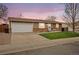 Charming single-story home featuring a well-maintained lawn, a two-car garage, and classic brick accents at 3308 E 118Th Way, Thornton, CO 80233