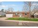Charming single-story home featuring a well-maintained lawn, a two-car garage, and classic brick accents at 3308 E 118Th Way, Thornton, CO 80233