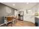 Modern kitchen with stainless steel appliances, white cabinetry, and an adjacent eat-in dining area at 3308 E 118Th Way, Thornton, CO 80233