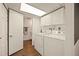 Practical laundry room with white washer, dryer, and ample storage for efficient home management at 3308 E 118Th Way, Thornton, CO 80233