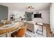 Open concept living area with modern design, dining space, and sleek TV at 3308 E 118Th Way, Thornton, CO 80233