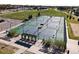 Aerial view of outdoor tennis and pickleball courts next to a park and parking lot with benches for players at 3308 E 118Th Way, Thornton, CO 80233