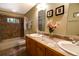 Well-lit bathroom features dual sinks, tiled floor, and decorative wall art and a tub shower combo at 446 Blue River Rd, Breckenridge, CO 80424