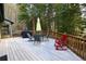 Spacious deck featuring outdoor seating, barbecue grill, and lush forest surroundings at 446 Blue River Rd, Breckenridge, CO 80424