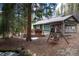 Beautiful home exterior showcasing a spacious deck, inviting wooden swing, and lush forest backdrop at 446 Blue River Rd, Breckenridge, CO 80424