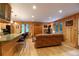 Cozy living room with hardwood floors, wood paneled walls, and a stone fireplace with a wood-burning stove at 446 Blue River Rd, Breckenridge, CO 80424