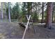 Quaint handmade backyard swing with a creek creating a peaceful and serene outdoor escape at 446 Blue River Rd, Breckenridge, CO 80424